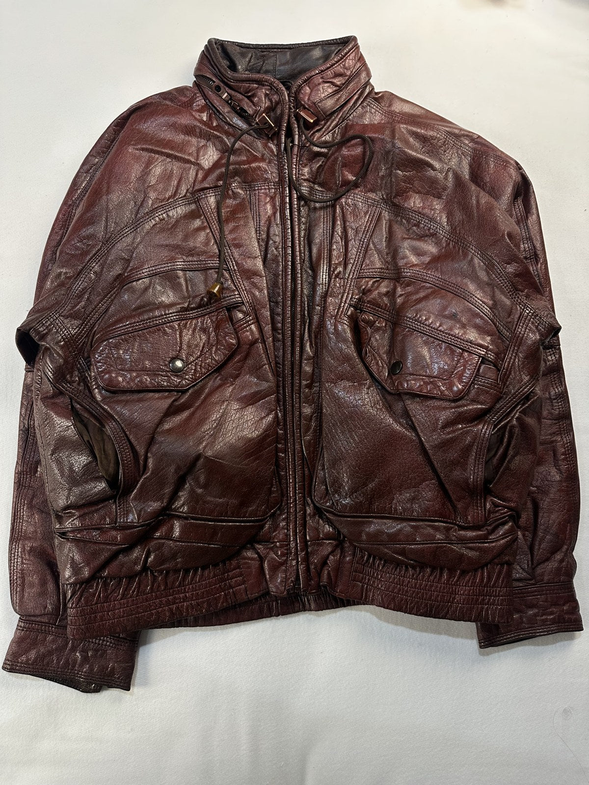 Burgundy leather harrington jacket in size XL laid flat from the front