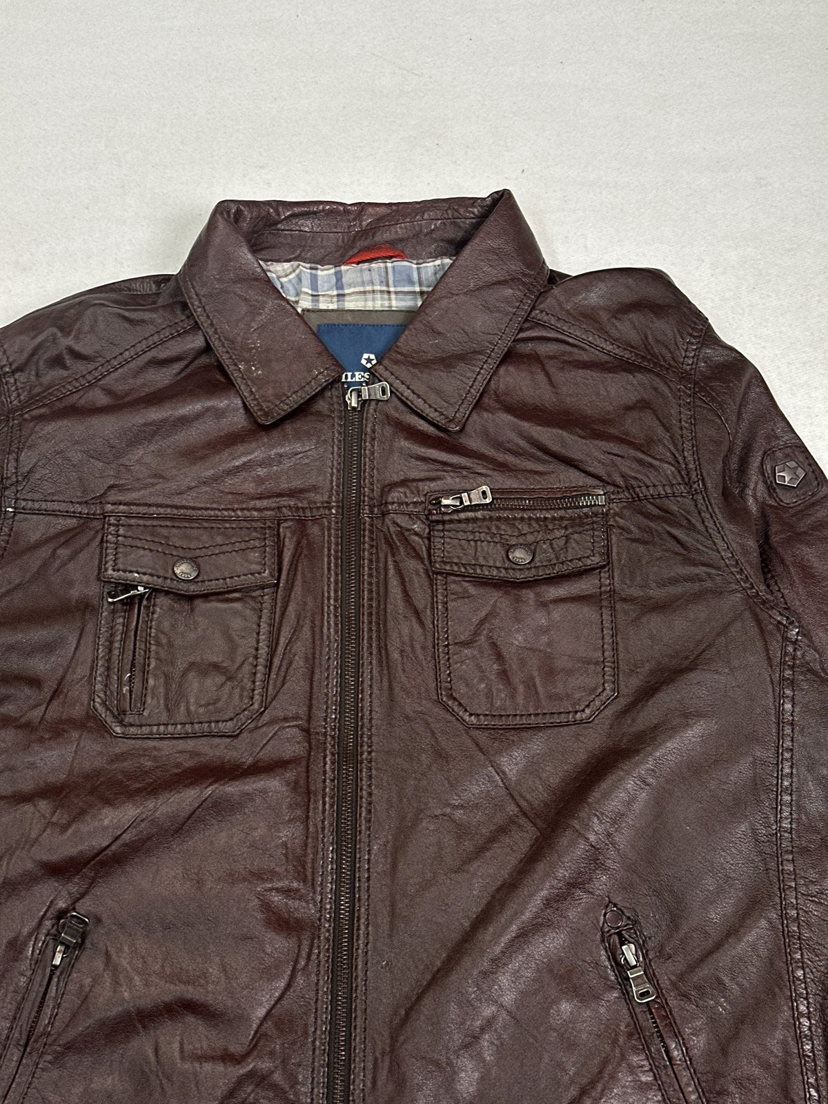 Collar and neckline of the burgundy leather trucker jacket