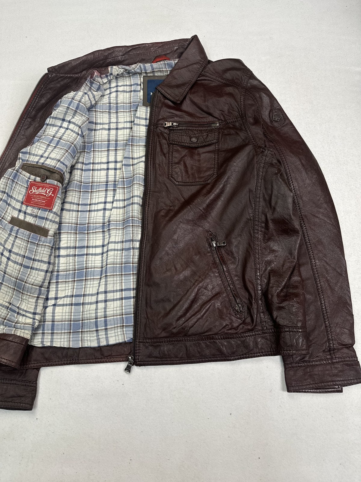Trucker jacket opened out to show the blue check lining inside