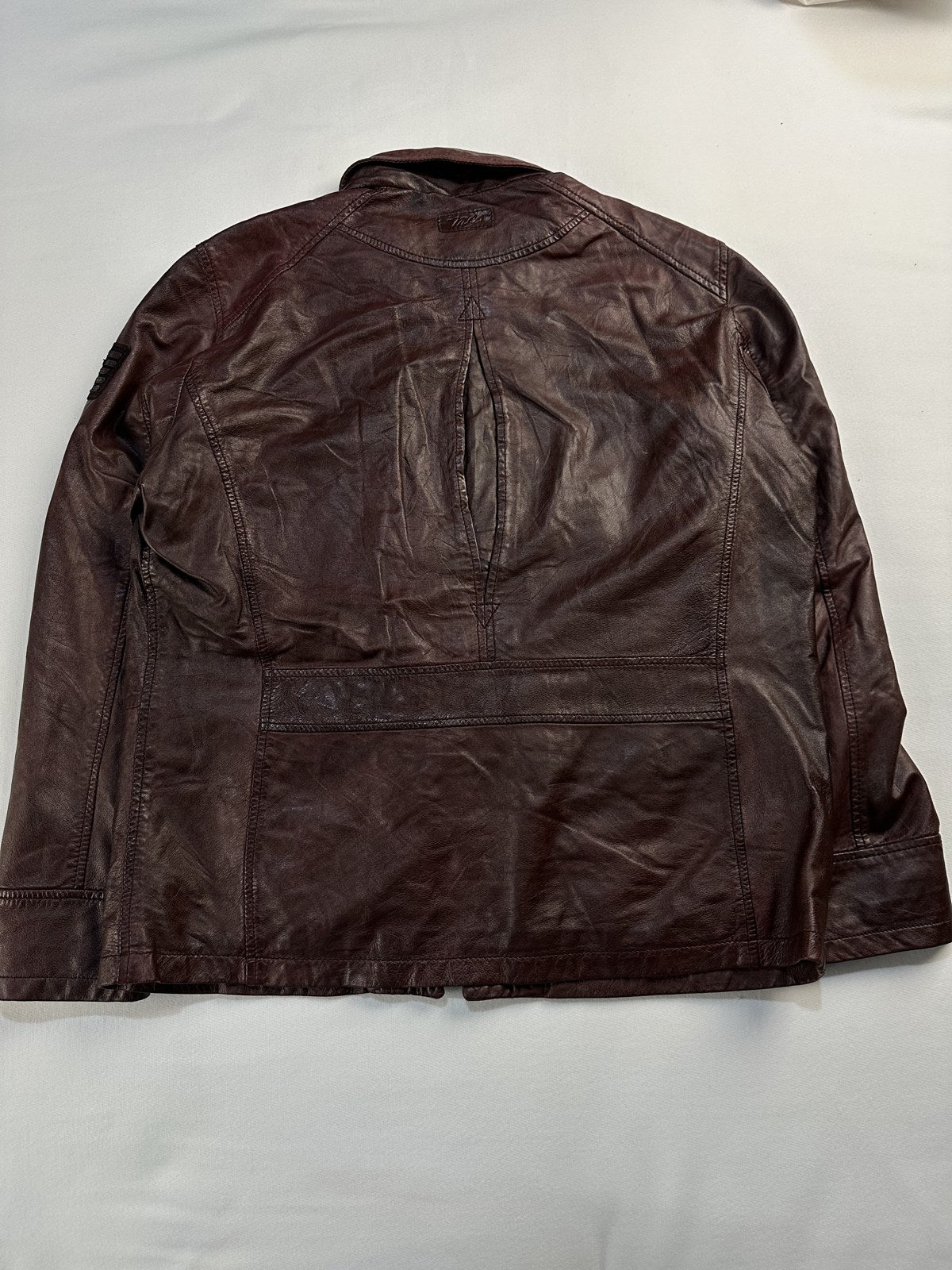 Back of the size XL burgundy trucker shown flat