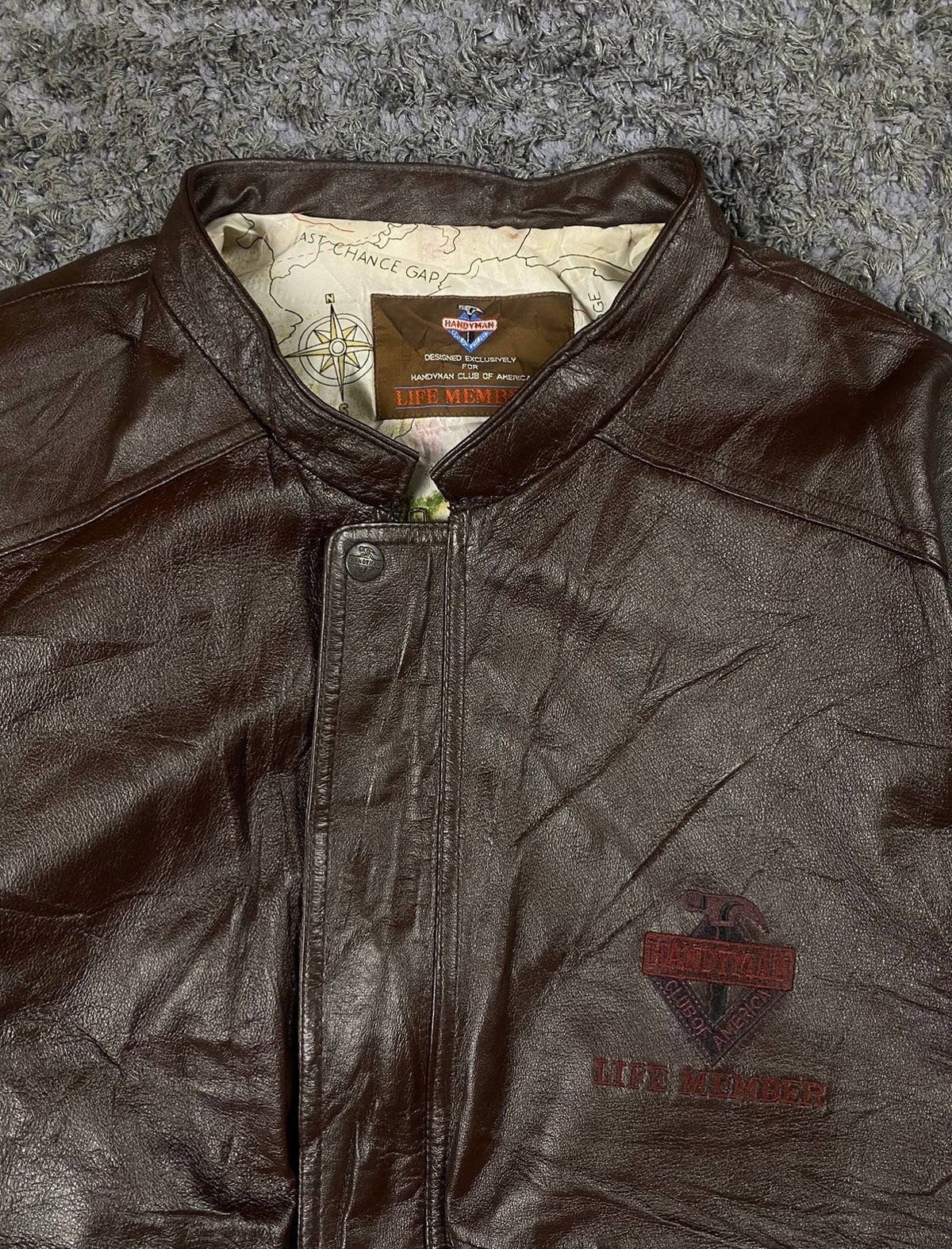 Close view of the neck zip with the printed lining showing at the open collar