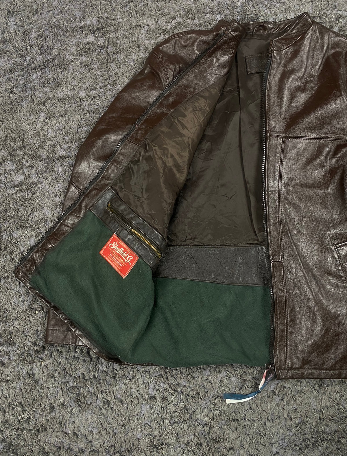 Green and brown lining inside the cafe racer, held open to show the interior