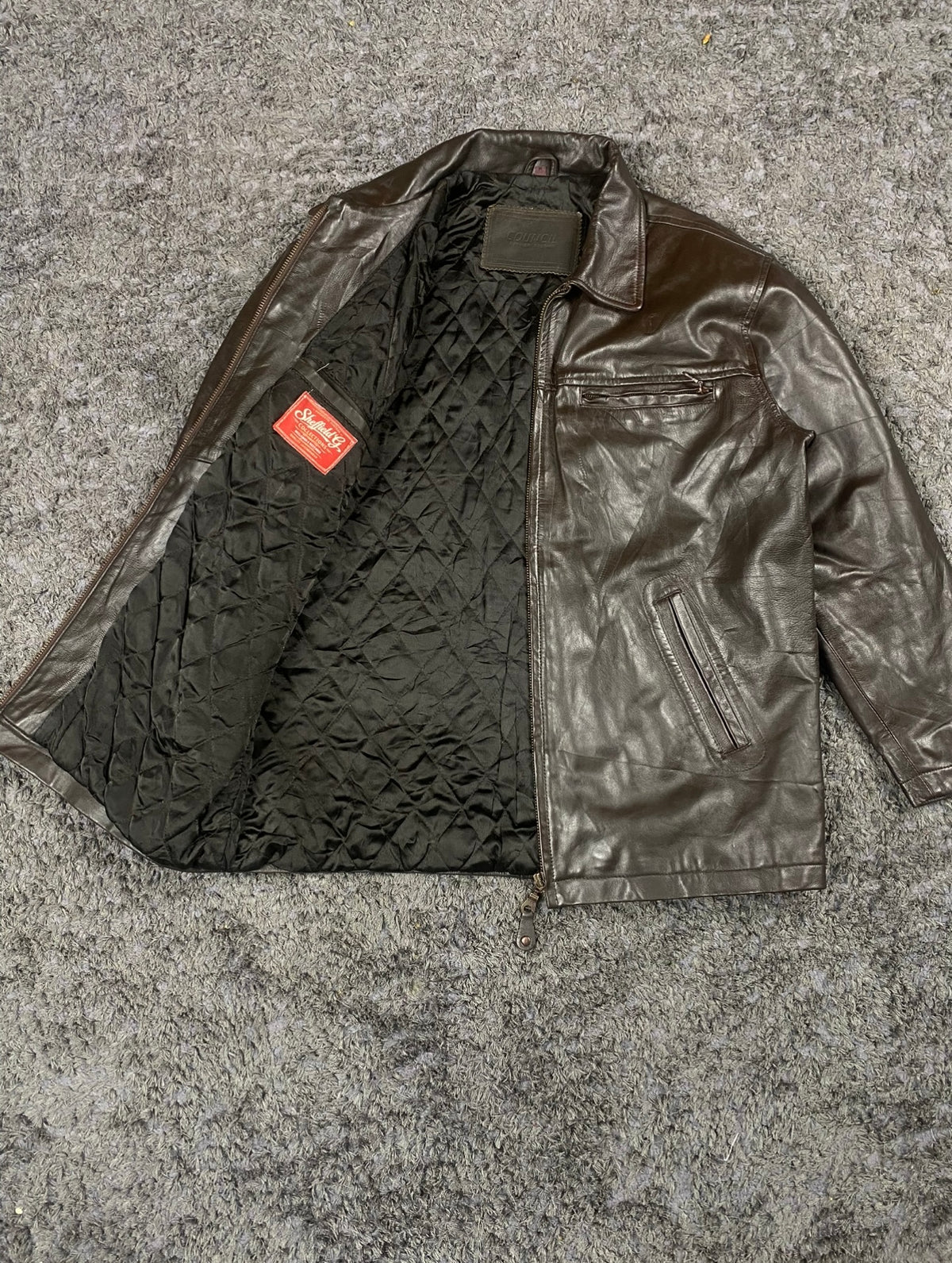 Brown cafe racer held open to reveal the quilted black lining running the full body