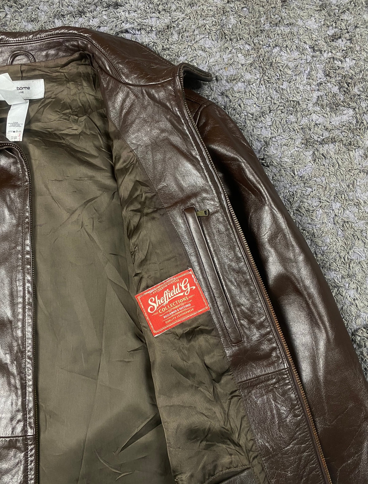 The size XL brown harrington, 28 inches long through the body