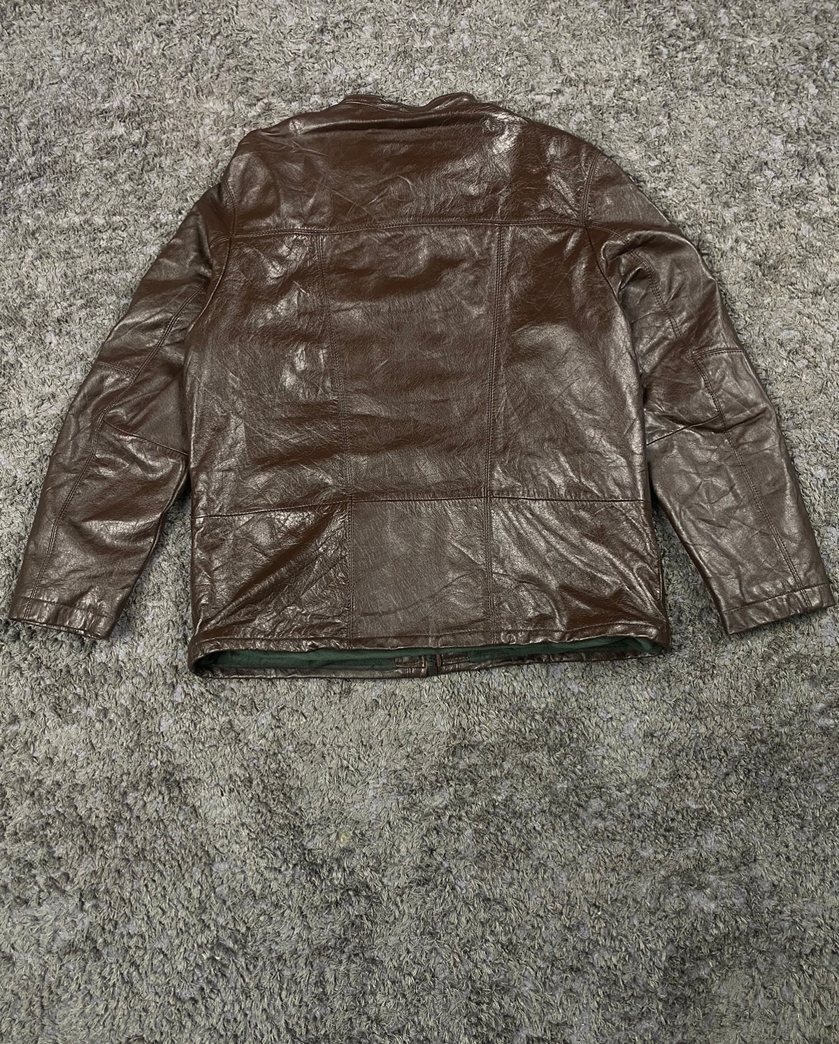 Back of the L brown cafe racer laid flat showing the plain leather panel and yoke seam