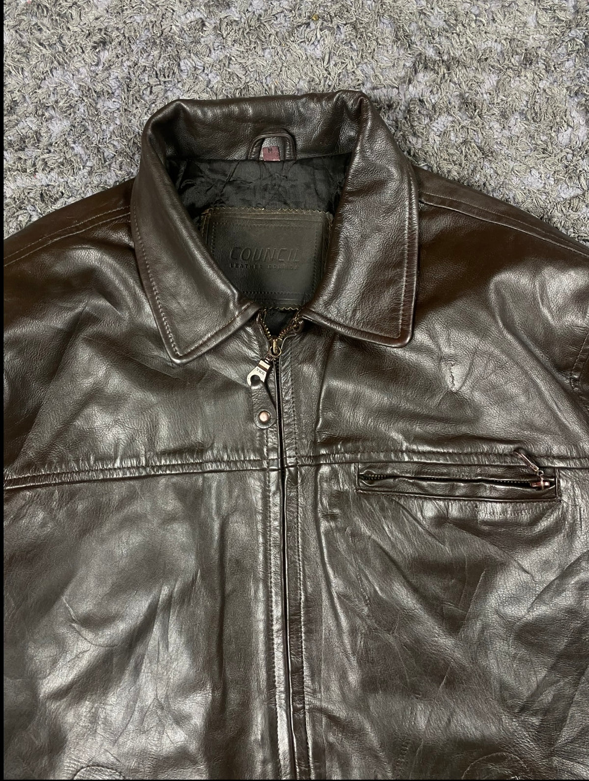 Pointed collar and neck zip at the top of this vintage brown leather jacket